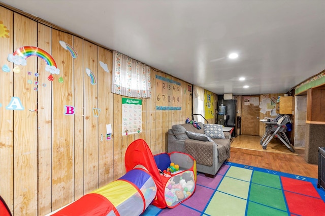 recreation room featuring wooden walls