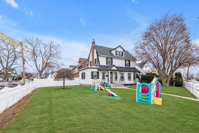 view of front of property with a playground and a front yard