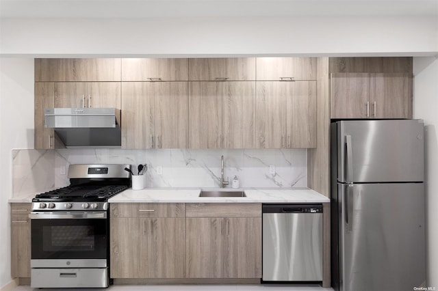 kitchen with light brown cabinetry, decorative backsplash, sink, and stainless steel appliances