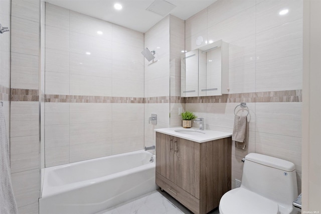 full bathroom with shower / bathing tub combination, vanity, toilet, and tile walls