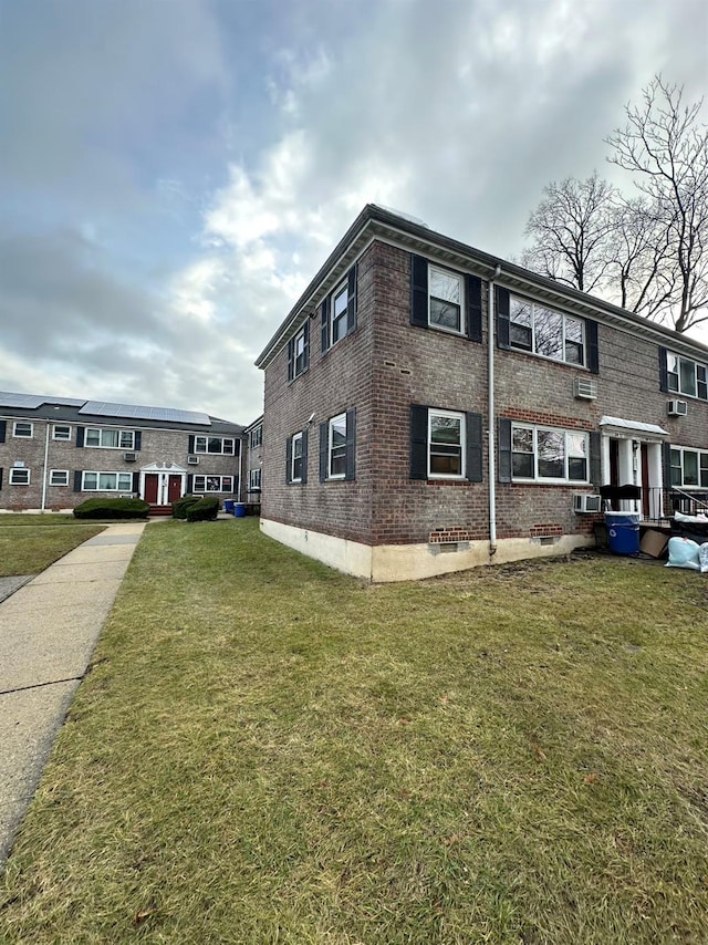 view of side of home featuring a yard