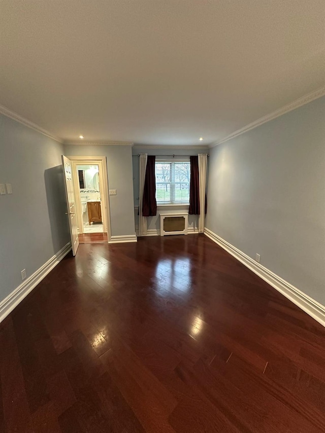 unfurnished room featuring dark hardwood / wood-style floors and ornamental molding