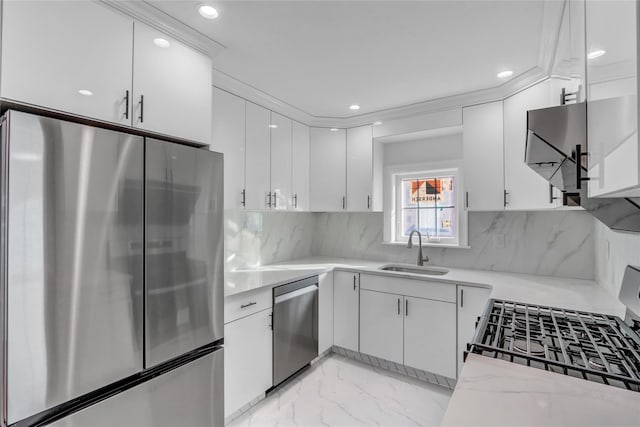 kitchen featuring tasteful backsplash, white cabinetry, sink, and appliances with stainless steel finishes