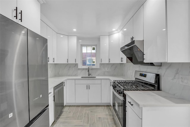 kitchen featuring backsplash, stainless steel appliances, extractor fan, sink, and white cabinetry