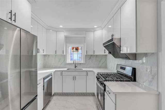 kitchen featuring white cabinets, backsplash, sink, and appliances with stainless steel finishes