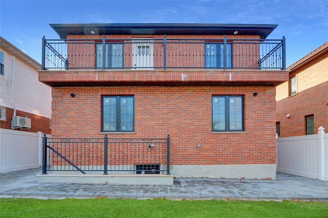 rear view of house with a patio and a balcony