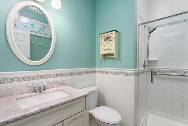 bathroom with walk in shower, vanity, toilet, and tile walls