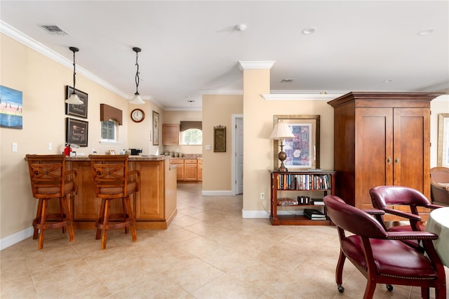 kitchen with kitchen peninsula, ornamental molding, light tile patterned floors, decorative light fixtures, and a breakfast bar area