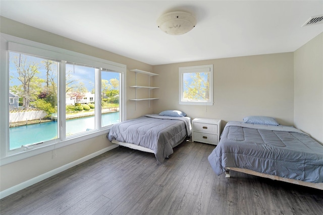 bedroom with dark wood-type flooring