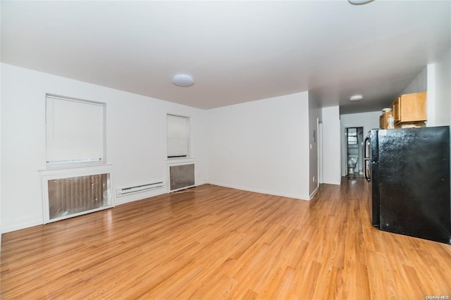 unfurnished living room featuring baseboard heating, radiator heating unit, and light hardwood / wood-style floors