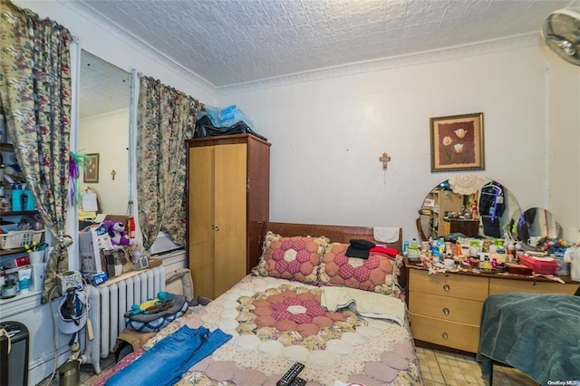 bedroom featuring radiator heating unit and crown molding