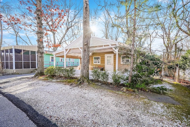 view of side of home with a sunroom