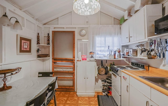 kitchen with lofted ceiling, white cabinetry, sink, and white range oven