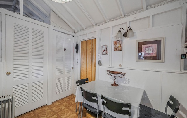 dining room with radiator heating unit and vaulted ceiling