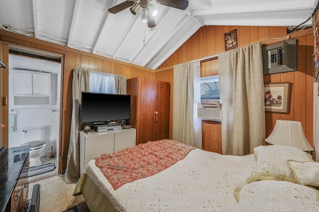 bedroom with ceiling fan, connected bathroom, lofted ceiling with beams, and wood walls