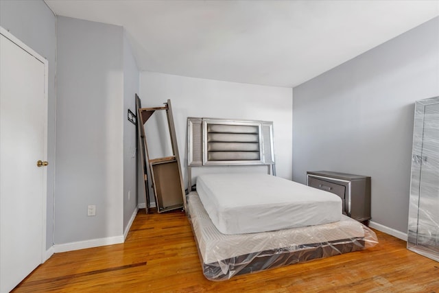 bedroom with hardwood / wood-style floors