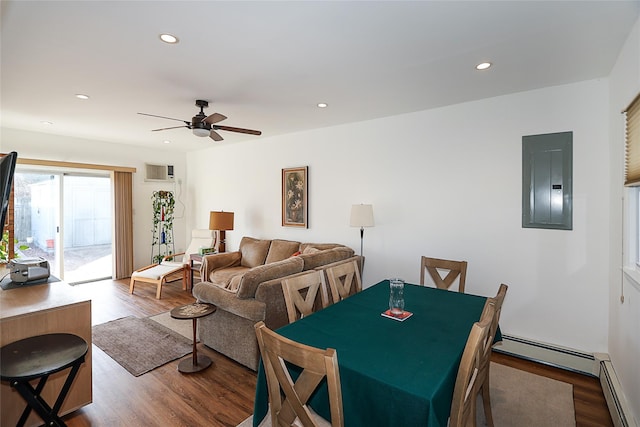 dining space featuring hardwood / wood-style floors, electric panel, baseboard heating, and ceiling fan