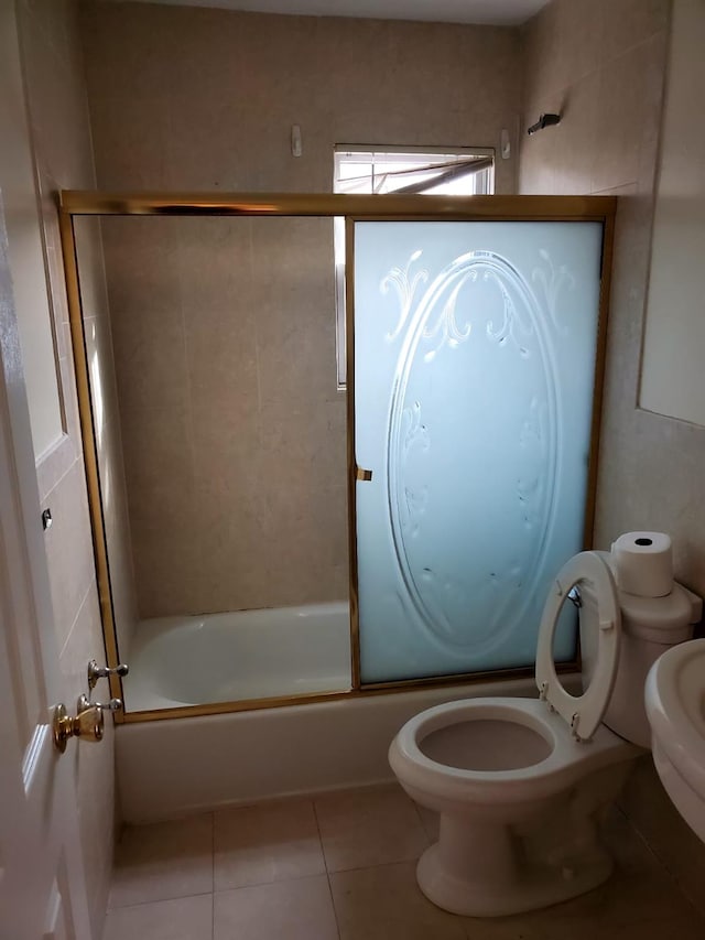 bathroom with tile patterned floors, enclosed tub / shower combo, and toilet