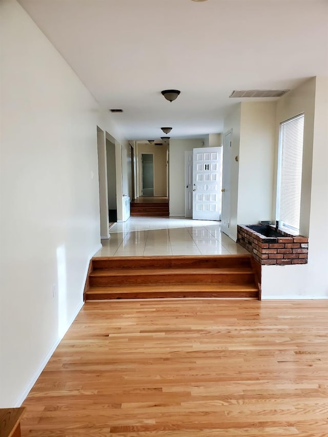 corridor featuring light hardwood / wood-style floors