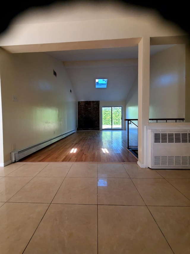 hall with lofted ceiling with beams, light tile patterned flooring, radiator heating unit, and baseboard heating