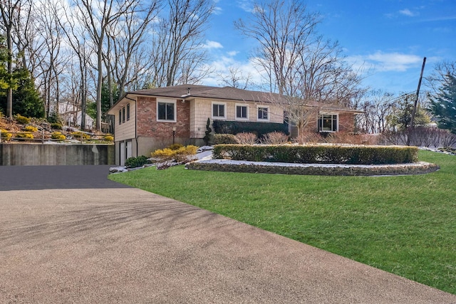 ranch-style home featuring a garage and a front yard