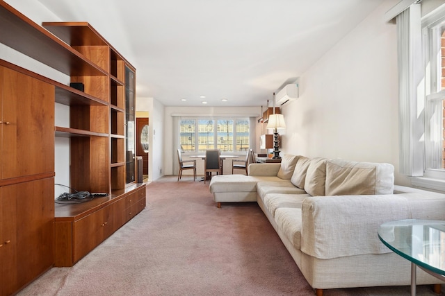 living room with an AC wall unit and carpet floors