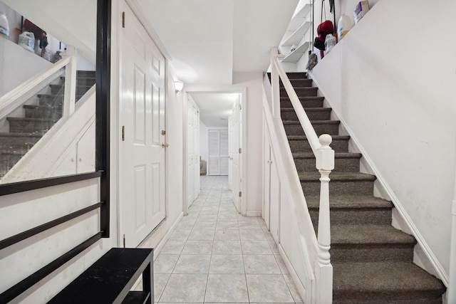 stairs featuring tile patterned flooring