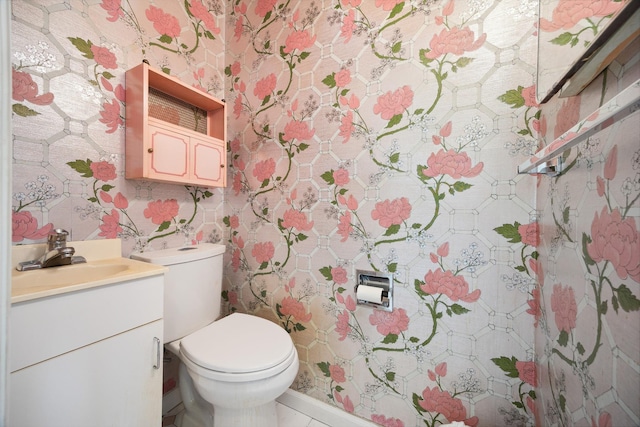 bathroom with tile patterned floors, vanity, and toilet