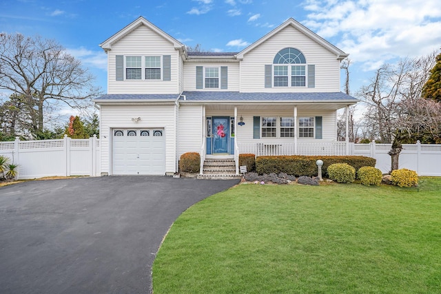 view of front of house with a front lawn, a garage, and a porch