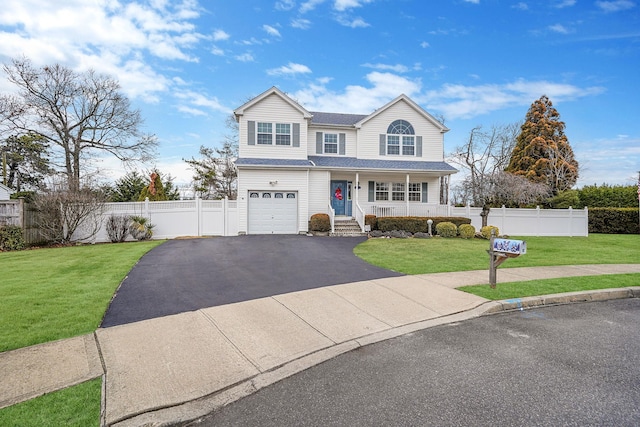 front facade with a front yard, covered porch, and a garage