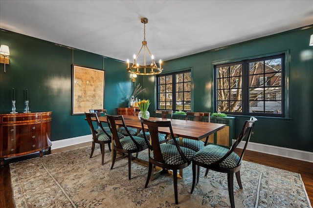 dining room featuring wood-type flooring and an inviting chandelier