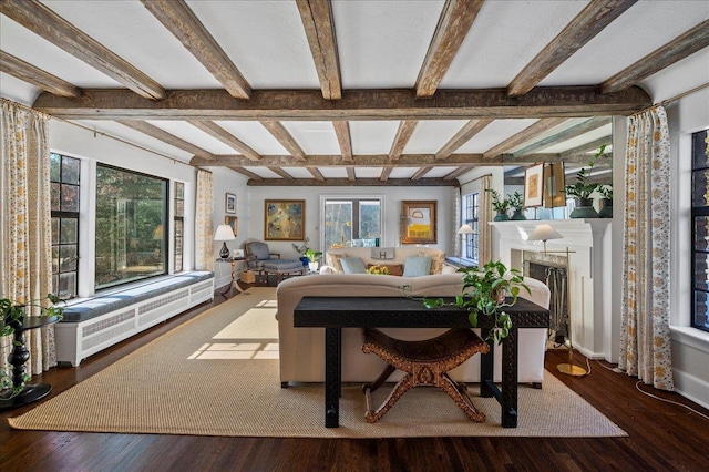 interior space with beam ceiling and dark hardwood / wood-style floors