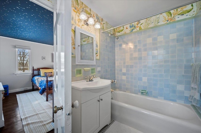 bathroom featuring tiled shower / bath combo, vanity, and wood-type flooring