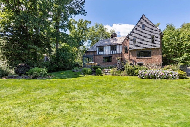 rear view of house with a lawn