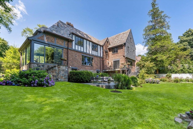 rear view of property with a patio area and a lawn