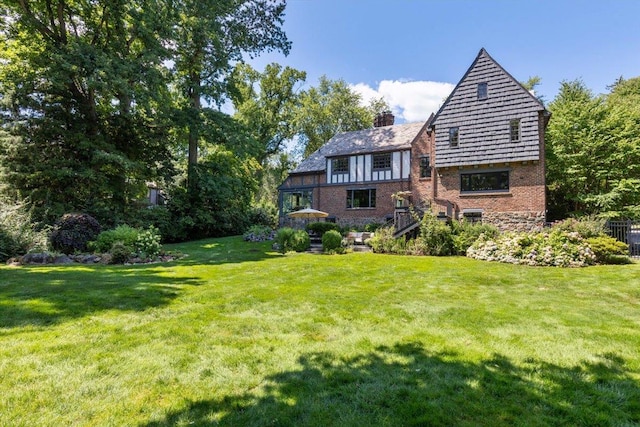 rear view of house featuring a lawn