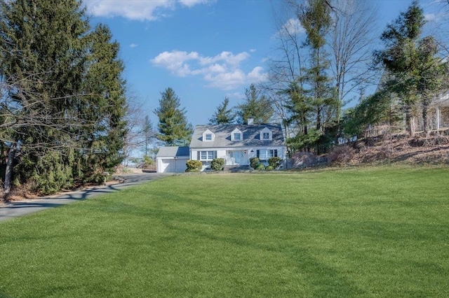 view of front of house featuring an attached garage and a front lawn