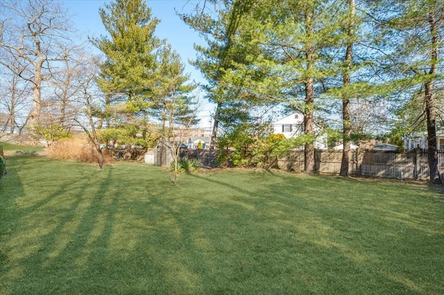 view of yard with an outdoor structure and fence