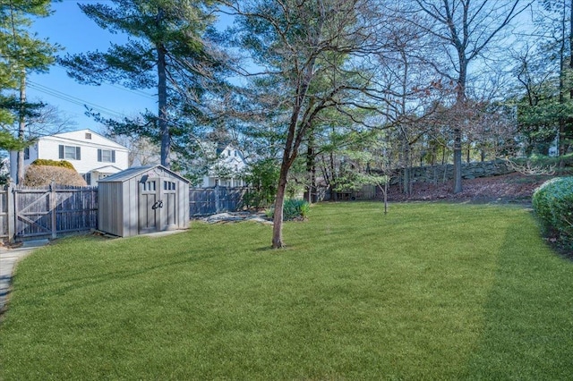 view of yard with a fenced backyard, a shed, and an outdoor structure