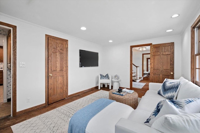 bedroom featuring ornamental molding, baseboards, and wood finished floors