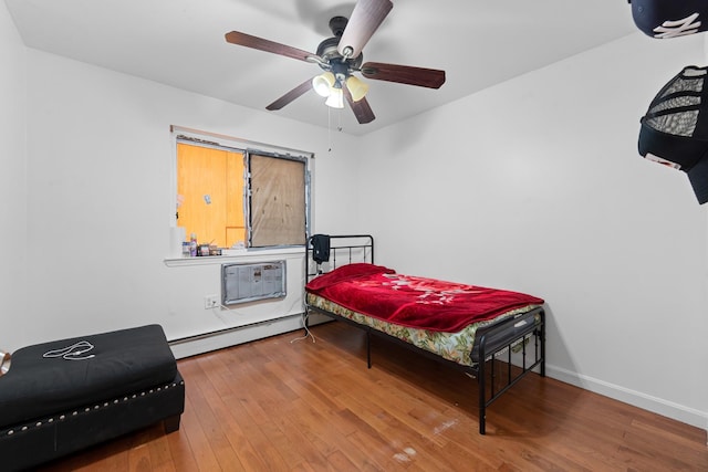 bedroom with hardwood / wood-style floors, ceiling fan, a wall unit AC, and a baseboard radiator