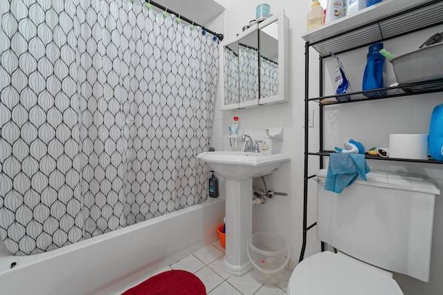 bathroom featuring tile patterned floors, toilet, and shower / bathtub combination with curtain