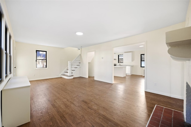 unfurnished living room with dark hardwood / wood-style flooring