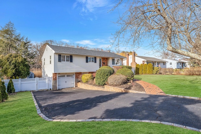 view of front of property with a garage and a front yard