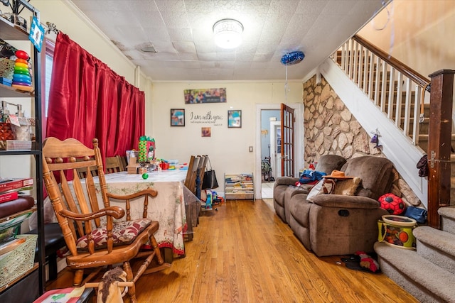 dining space with light hardwood / wood-style floors and crown molding