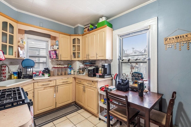 kitchen featuring light brown cabinets, sink, decorative backsplash, light tile patterned floors, and ornamental molding