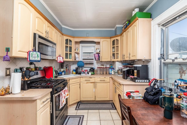 kitchen featuring decorative backsplash, appliances with stainless steel finishes, ornamental molding, sink, and light tile patterned floors