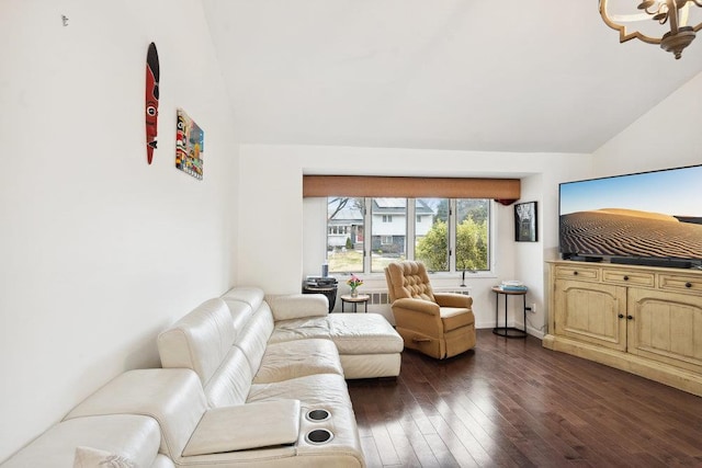 living room featuring dark wood-type flooring and vaulted ceiling