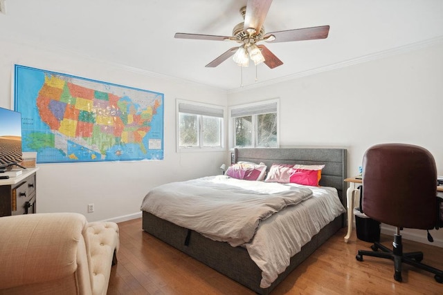 bedroom with wood-type flooring, ceiling fan, and ornamental molding