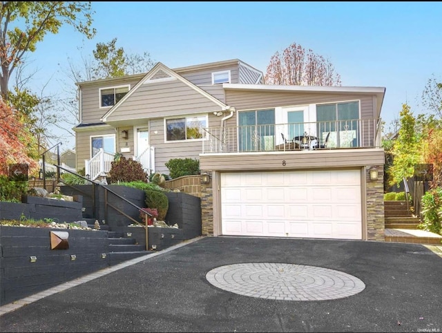 view of front facade featuring a balcony and a garage